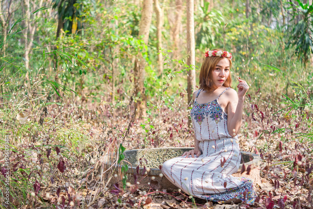 Beautiful asian woman wear dress in the forest on daylight,Thailand people go to the wood for take a picture Beautiful asian woman wear dress in the forest on daylight,Thailand people go to the wood for take a picture