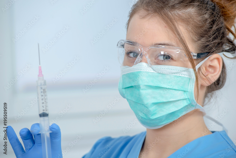 young nurse preparing injection with syringe in hospital young nurse preparing injection with syringe in hospital