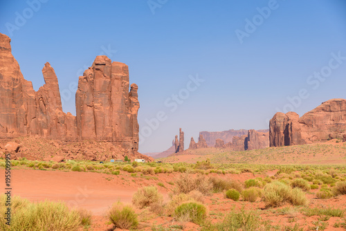 Scenic Drive on Dirt Road through Monument Valley, The famous Buttes of Navajo tribal Park, Utah - Arizona, USA. Scenic road and red rock formations.