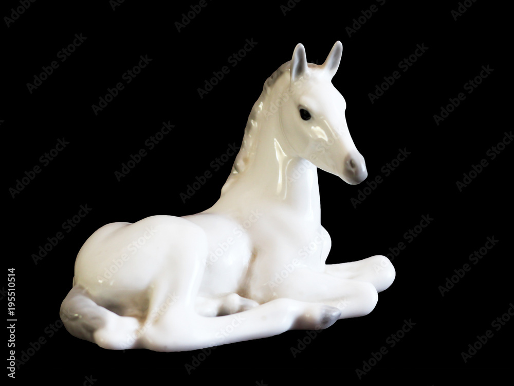 Naklejka premium Toy horse made of ceramic isolated on black background