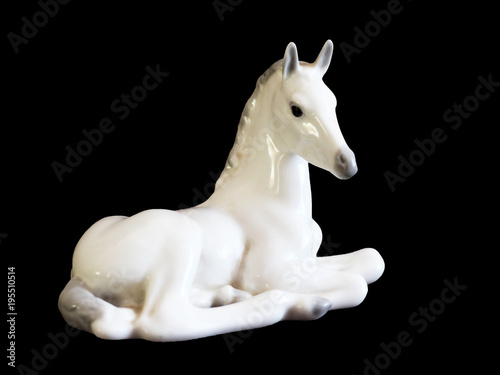 Toy horse made of ceramic isolated on black background © sabdiz