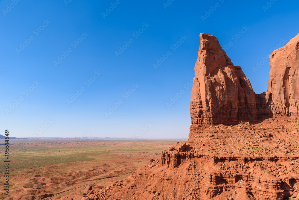 Scenic Drive on Dirt Road through Monument Valley, The famous Buttes of Navajo tribal Park, Utah - Arizona, USA. Scenic road and red rock formations. Scenic Drive on Dirt Road through Monument Valley, The famous Buttes of Navajo tribal Park, Utah - Arizona, USA. Scenic road and red rock formations.