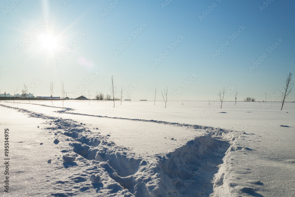 shot of snowy landscape with two footpathes