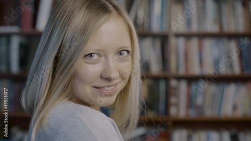 Portrait of young beautiful caucasian blonde woman turning head and smiling at camera 4k