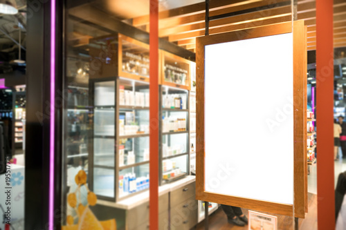 empty wood frame poster display on glass window at shop storefront,sale and discount promotion information for announcement successful business marketing,selective focus