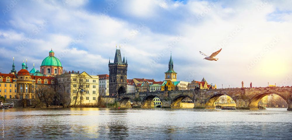 Cityscape of Prague with medieval towers and colorful buildings, famous Charles Bridge and tower, Czech Republic