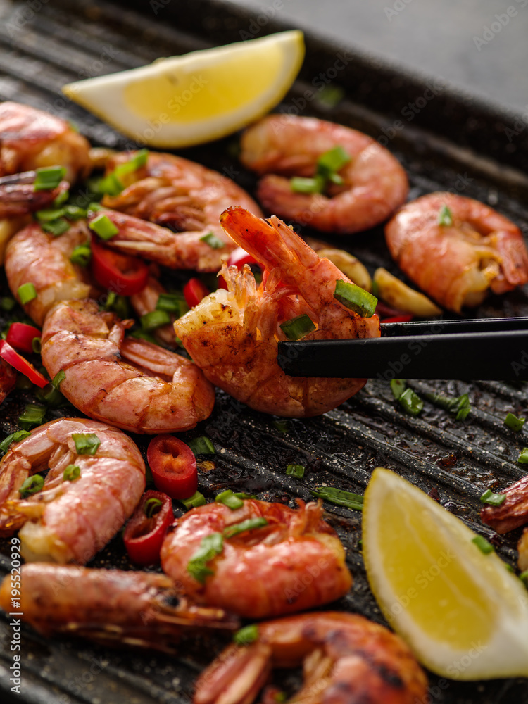 Large grilled BBQ shrimp with sweet chili sauce, green onion and lemon.