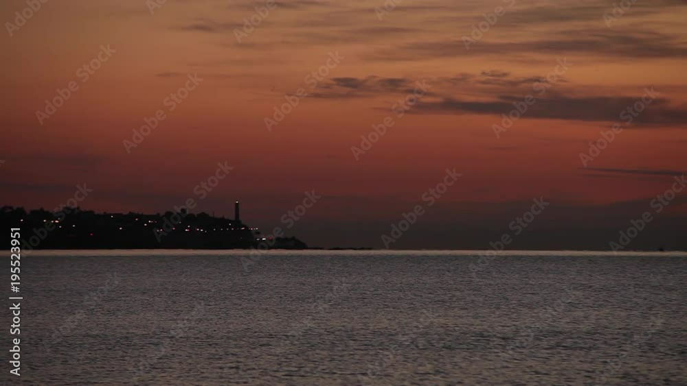 A Lighthouse during red sunset, near the Ocean, Spain, Malaga A Lighthouse during red sunset, near the Ocean, Spain, Malaga