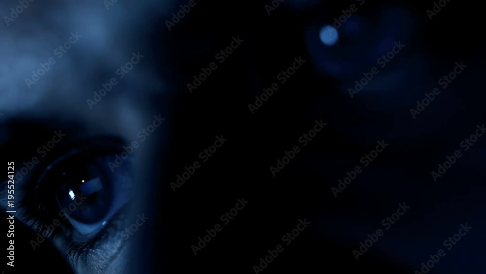 eyes of hackers attacking the system on the computer in the dark