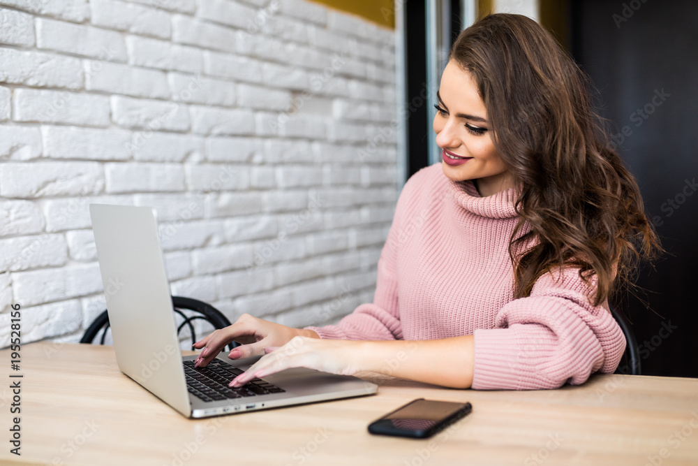 Happy Young Beautiful Woman Using Laptop, Indoors at home Happy Young Beautiful Woman Using Laptop, Indoors at home