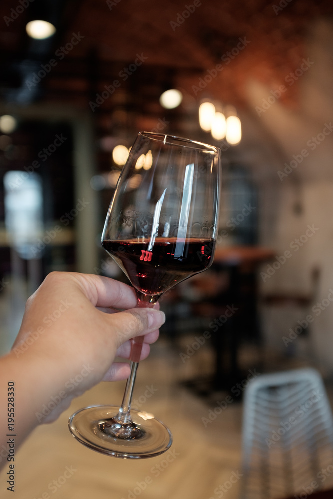 A glass of red wine in a woman's hand