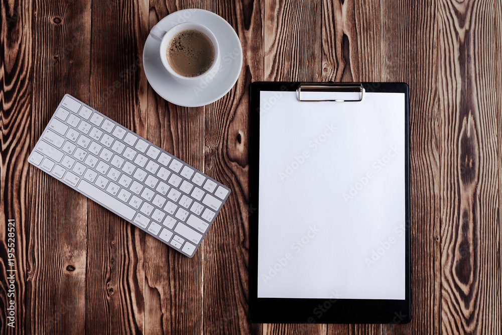 the white open notepad and computer keypad isolated on the wooden desktop the white open notepad and computer keypad isolated on the wooden desktop