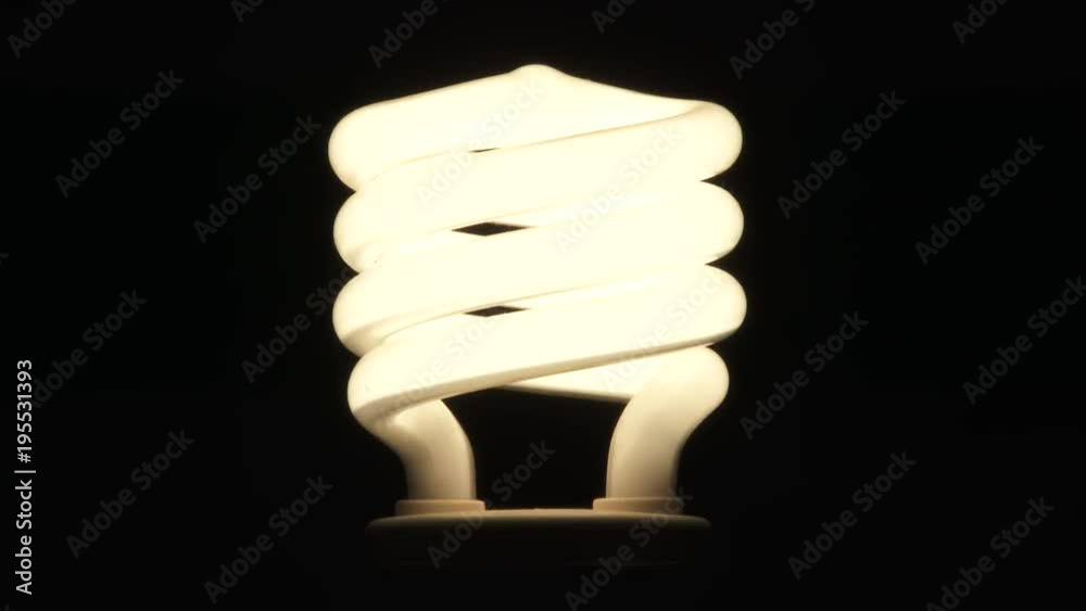 Close up on centered compact fluorescent lamp light bulb turning on, flickering and turning off