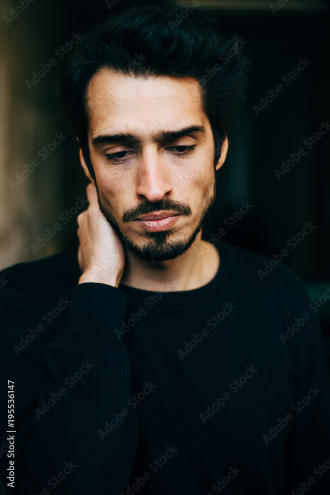 Sad and depressed Mediterranean looking young man