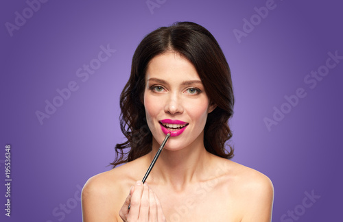 beautiful woman with make up brush for lipstick