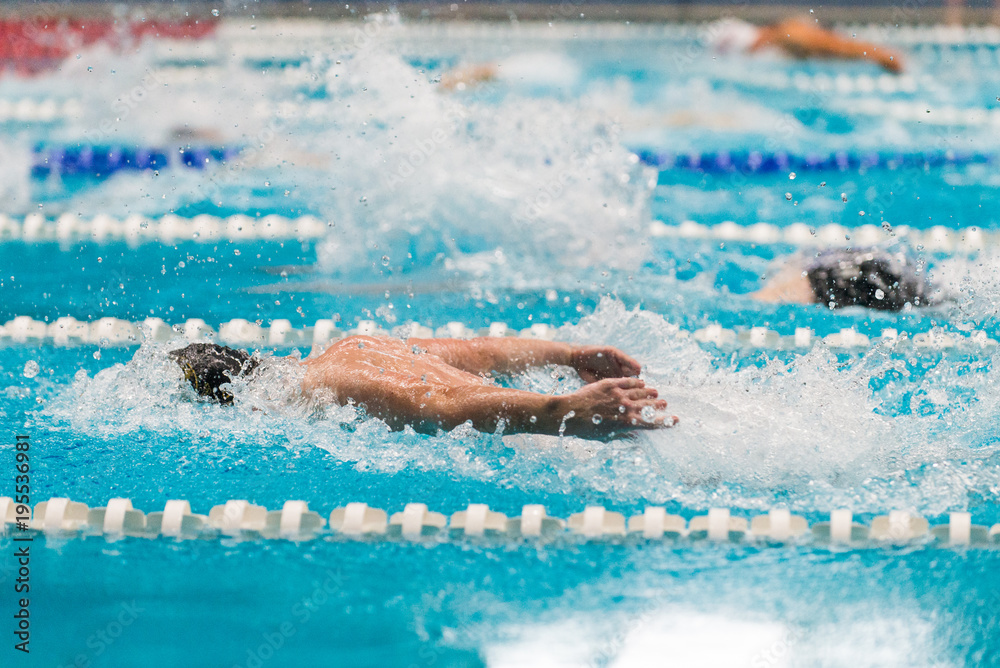 Male swimmer doing butterfly during competition