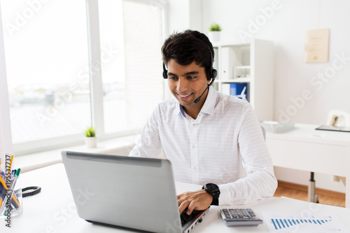 businessman with headset and laptop at office