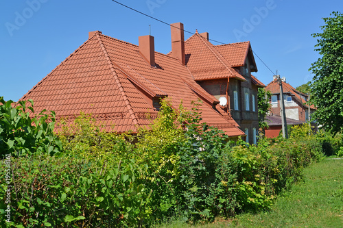 The house with a ceramic tile roof. Settlement Amber, Kaliningrad region