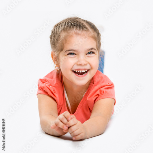 Portrait of a beautiful little cheerful girl. The child laughs