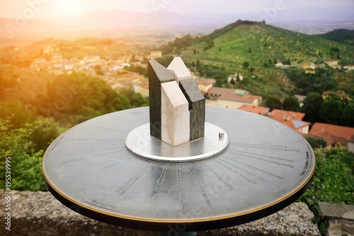 Close-up of marble toposcope with italian toscana landscape. Direction Indicator. Navigation system. Sunset time. Travel concept photo