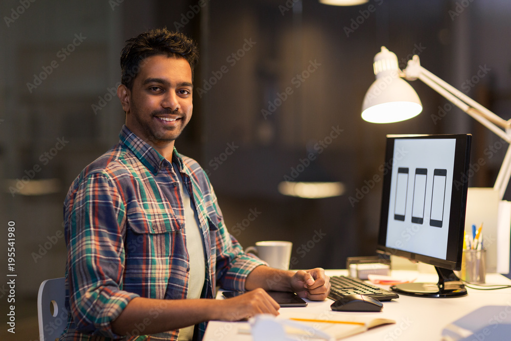 designer with computer working at night office designer with computer working at night office