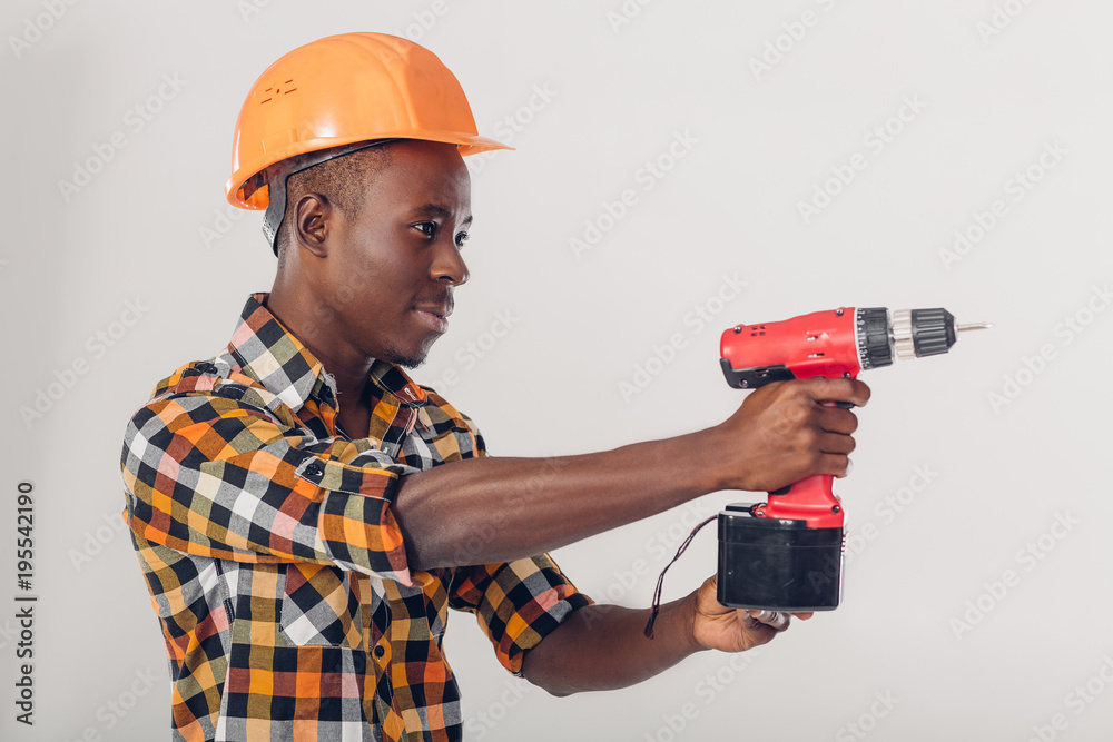 African American worker uses electric screwdriver
