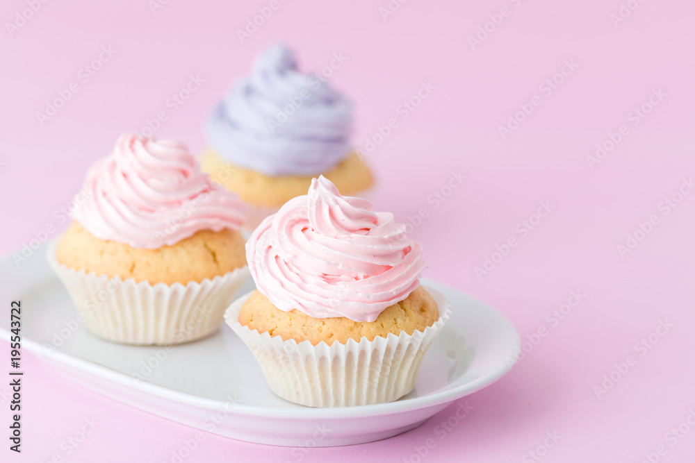 Cupcake decorated with pink and violet buttercream on pastel pink background. Sweet beautiful cake. Horizontal banner, greeting card for birthday, wedding. Close up photography. Selective focus
