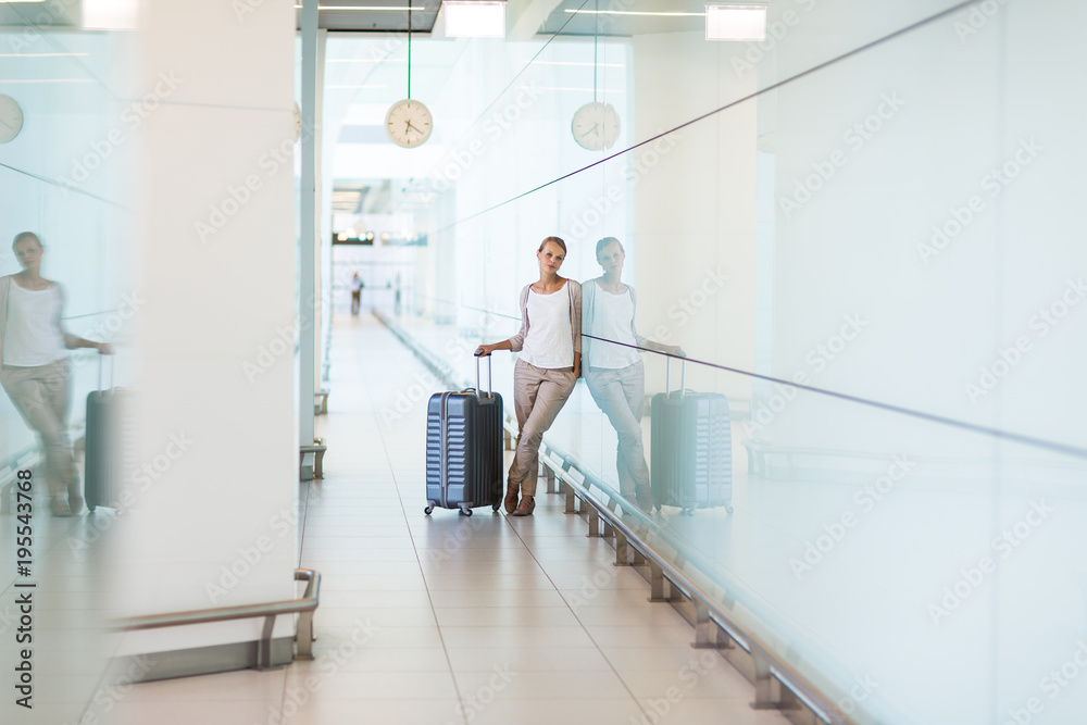 Young female passenger at the airport, about to check-in Young female passenger at the airport, about to check-in