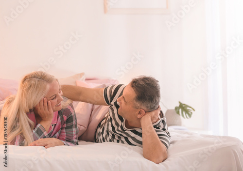 Senior couple on bed together