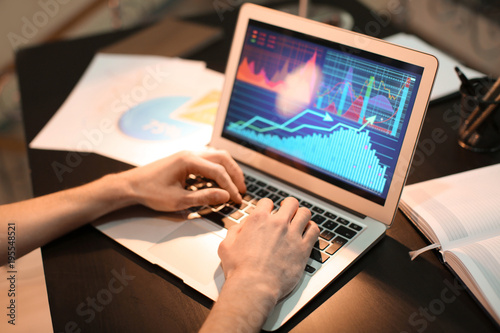 Man working with laptop indoors, closeup