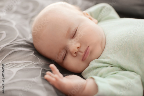 Cute little baby sleeping on bed © Africa Studio