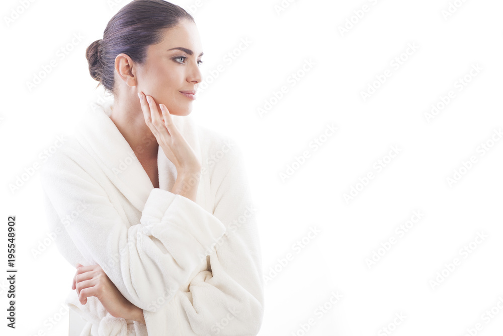 Beautiful and natural woman in white bathrobe is touching her skin. Relax and comfortable feelings only. Beautiful and natural woman in white bathrobe is touching her skin. Relax and comfortable feelings only.