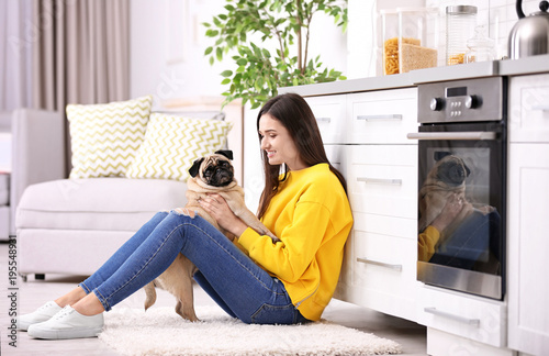 Woman with cute dog at home...
