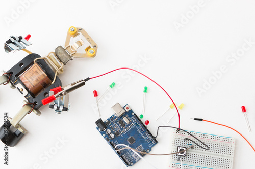 A metal robot and an electronic board that can be programmed. Robotics and electronics. A robot assembly builder. Laboratory in the school. Mathematics, engineering, science.