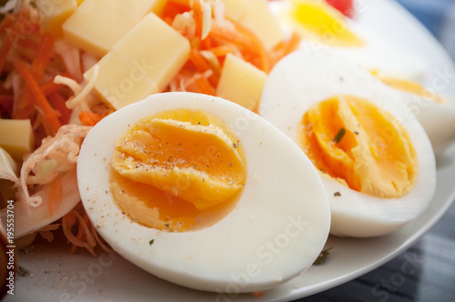 closeup of hard boiled eggs with vegetables in a plate