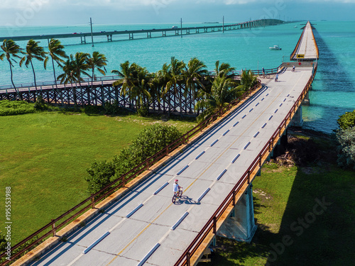 Boy cycling on a bridge