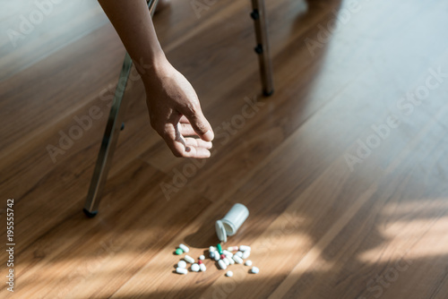 The man committing suicide by overdosing on medication. Close up of overdose pills and addict..