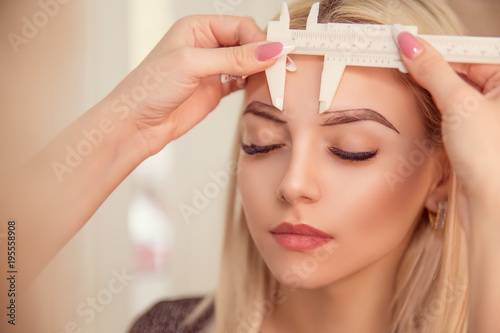 Microblading eyebrows work flow in a beauty salon photo