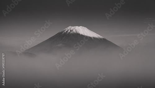 Top of Mt.Fuji with fog in autumn season morning , process in black and white tone