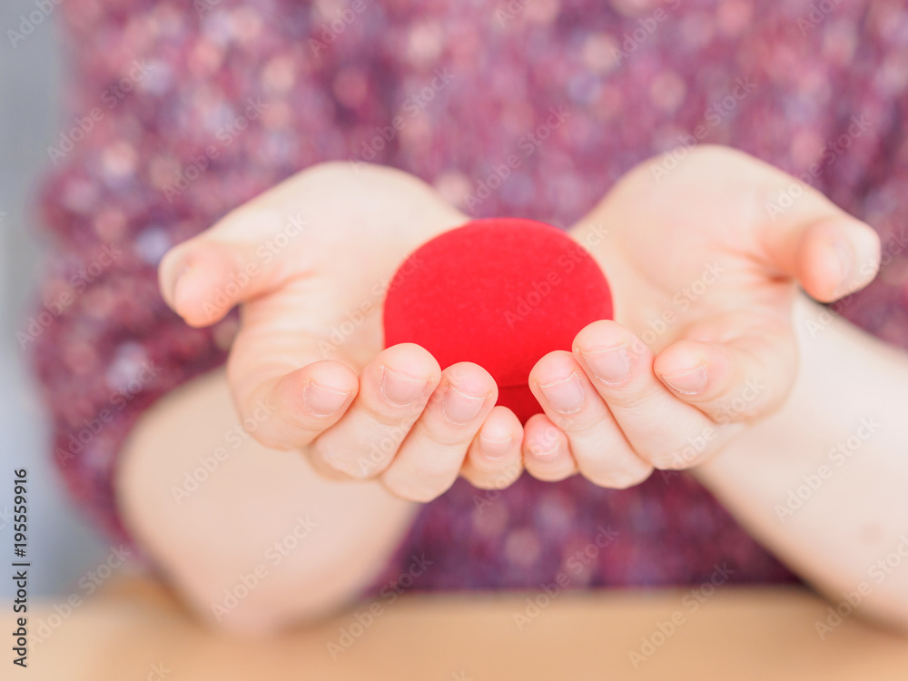 Red gift box hold in woman hands like heart shape. Concept of the engagement gift. Valentine surprise gift, symbol of love. Red gift box hold in woman hands like heart shape. Concept of the engagement gift. Valentine surprise gift, symbol of love.
