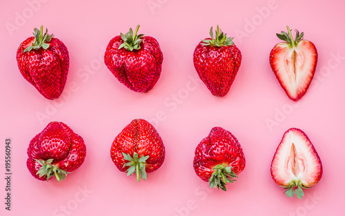set of strawberries in two lines on pink fashion background