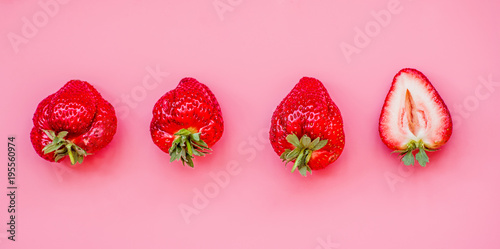 raw of fresh juicy strawberries on pink background. flat lay top view