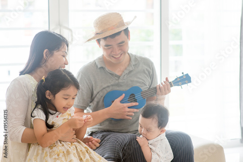 Asian family playing music instrument