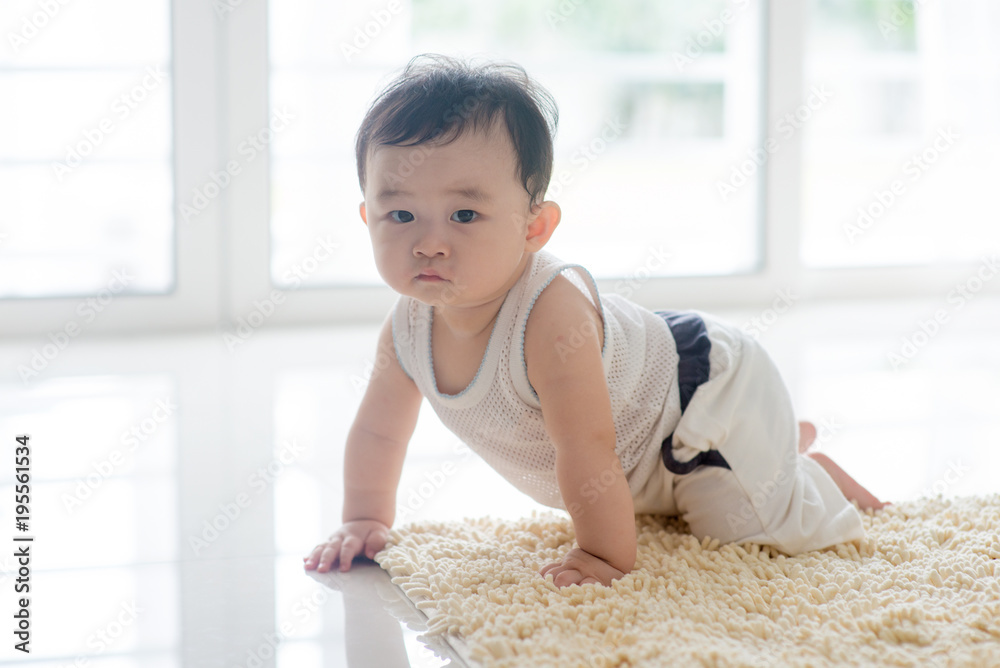 Healthy baby boy crawling on carpet. Healthy baby boy crawling on carpet.