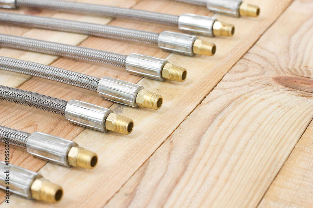 Fototapeta premium Hydraulic hoses. lines flexible object for industry on wooden background.