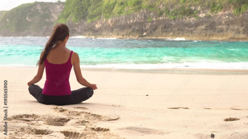 Young woman practicing yoga on the beach. Exercises calmness, harmony. Young woman practicing yoga on the beach. Exercises calmness, harmony.