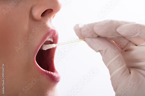 Dentist Taking Saliva Test Of A Patient photo