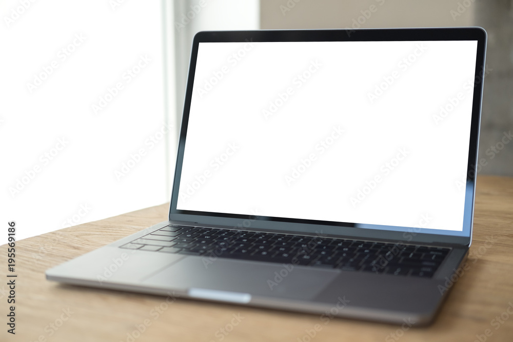 Mockup image of laptop with blank white desktop screen on wooden table in modern cafe Mockup image of laptop with blank white desktop screen on wooden table in modern cafe