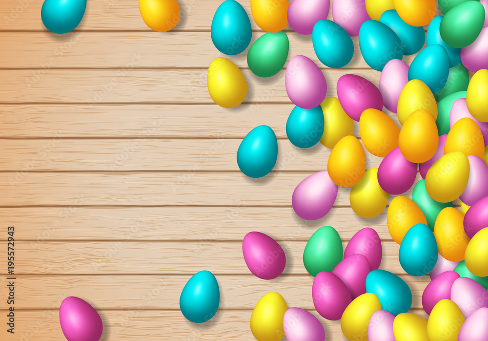 Easter frame with shiny colorful happy eggs spread over wooden background