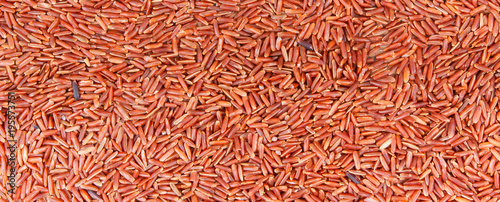 Heap of red rice as background, healthy, gluten free nutrition concept, copy space for text